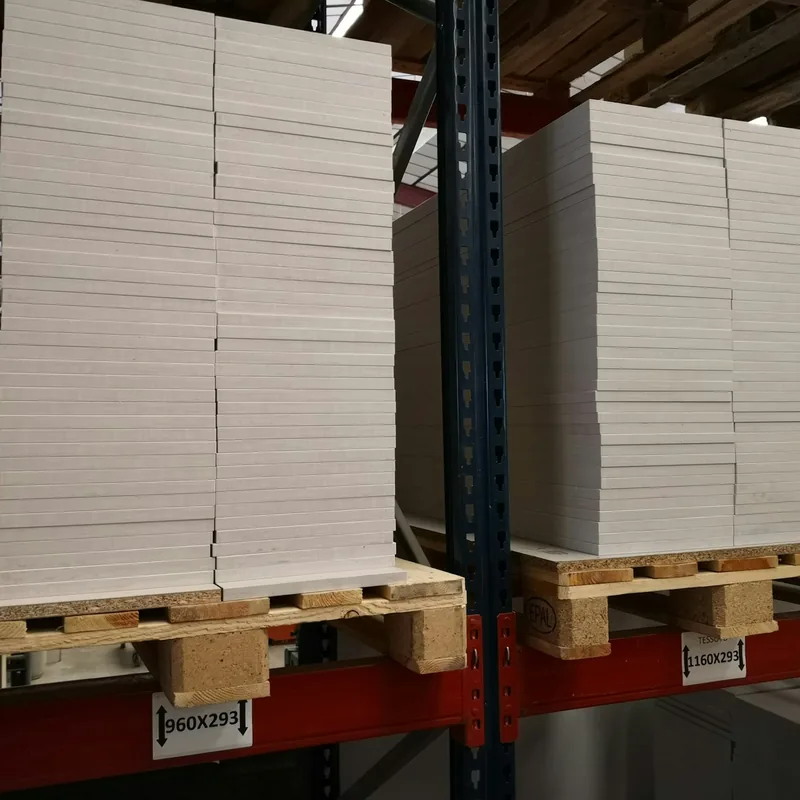Pallets of stacked stock on red pallet racking