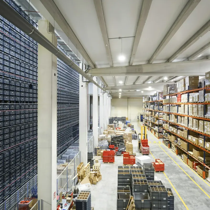 Storeroom with a wall of parts drawers and racking of boxed stock