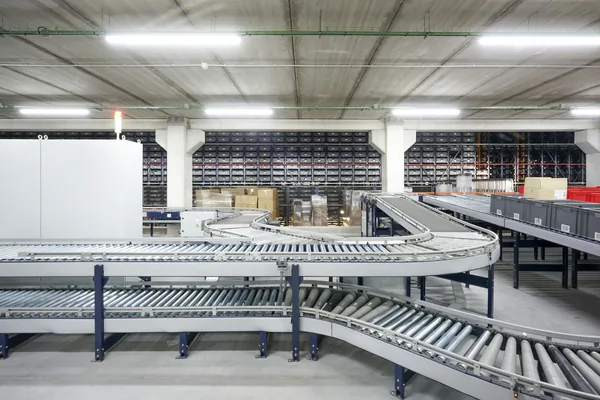 Roller conveyors curving through a large warehouse