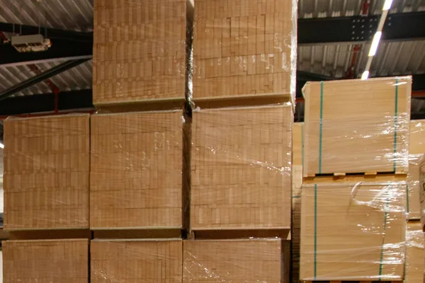 Stretch-wrapped pallets of boxed goods stacked in a warehouse