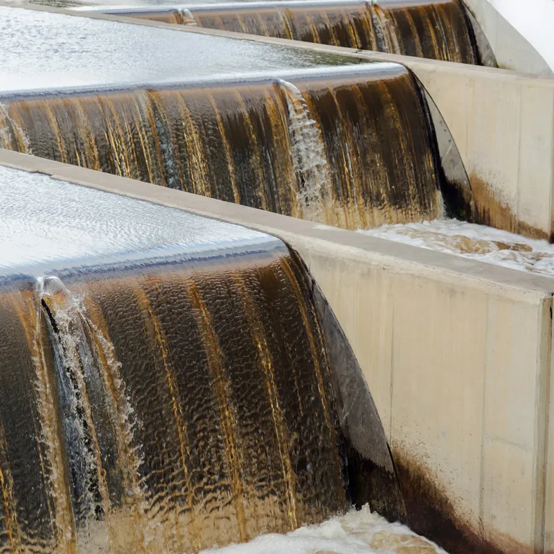 Water flowing over the weirs of a treatment basin
