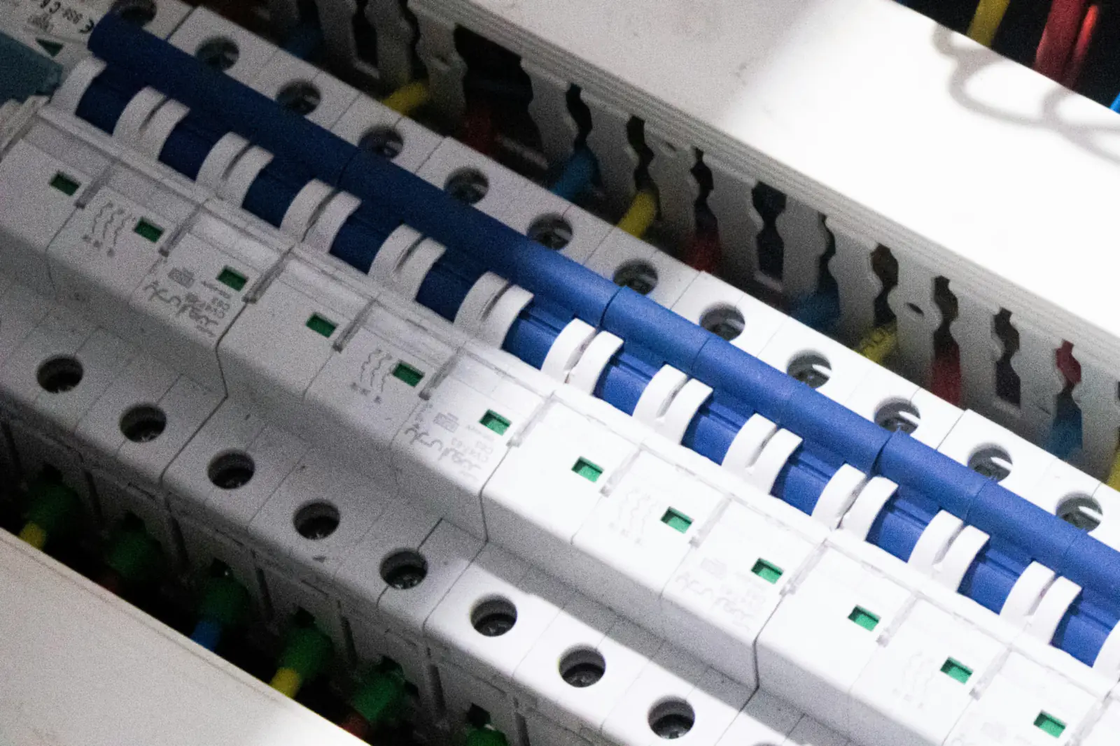 Row of modular circuit breakers and control wiring in an electrical panel