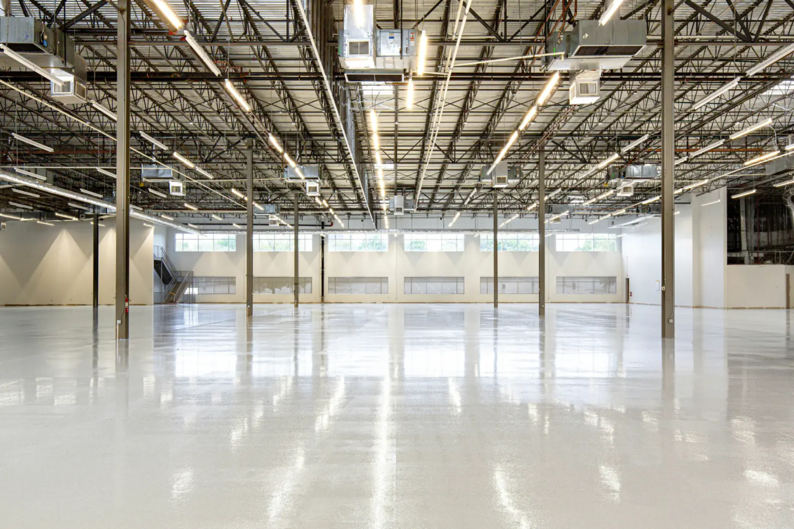 Large, empty industrial building with a clean polished concrete floor