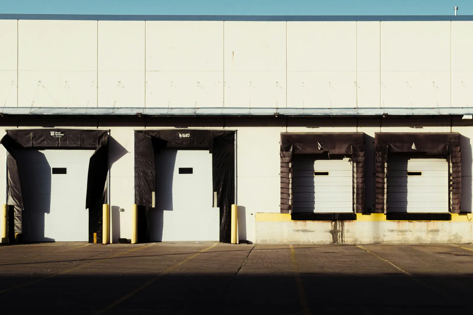 Row of loading dock doors on an industrial building