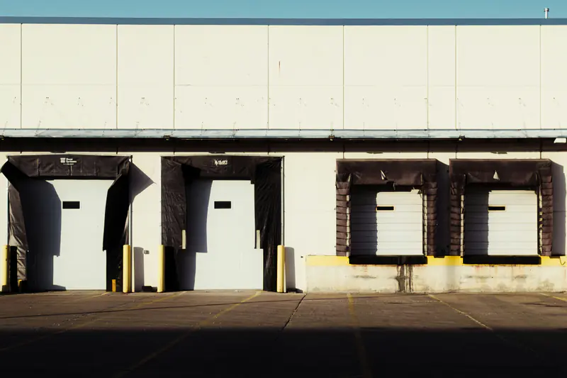 Row of loading dock doors on an industrial building