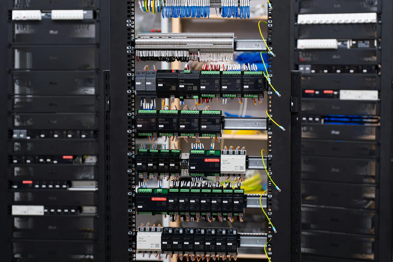 Automation cabinet with rows of DIN-rail control modules and wiring