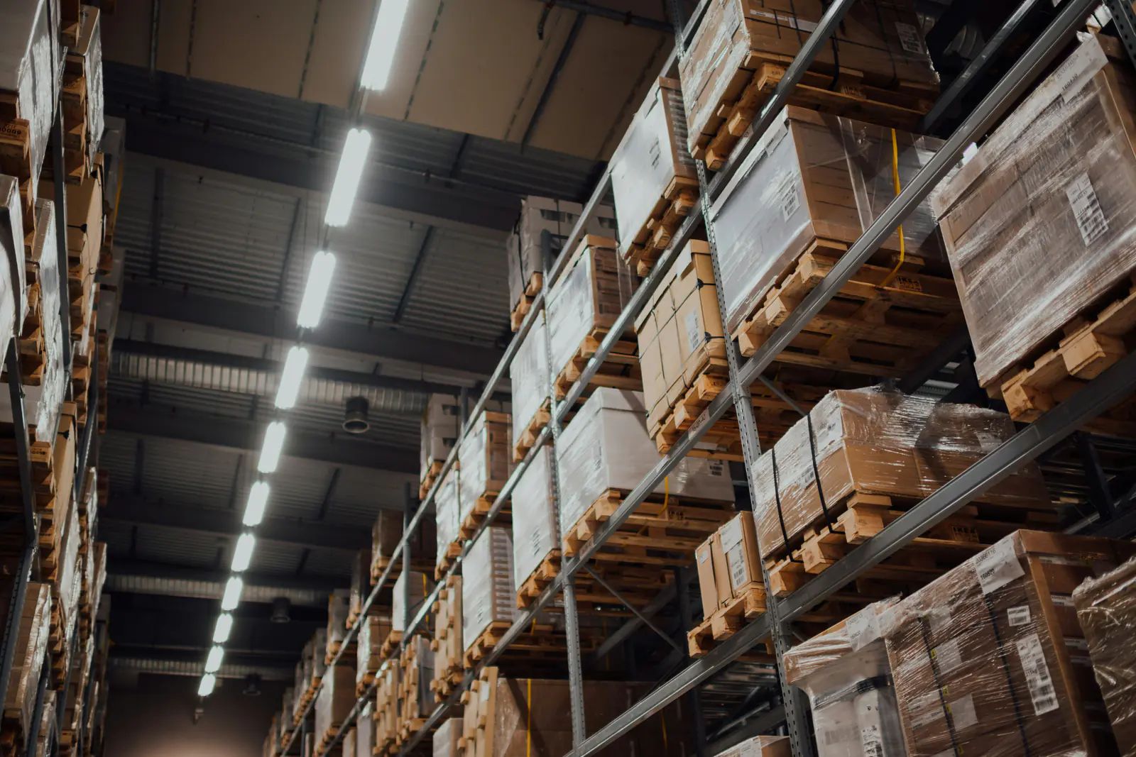Boxed goods on pallets in tall warehouse racking